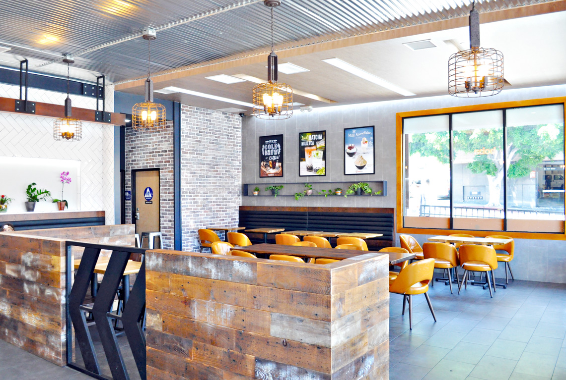An interior perspective view of boba time store. exposed concrete floor. brick wall.