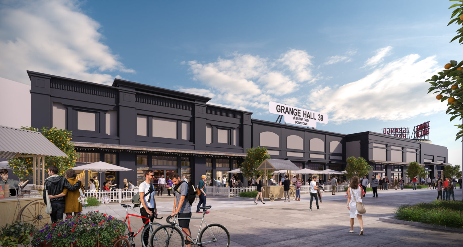 A perspective view of the building exterior. Storefront glazing and dark gray painted exterior wall. Exterior seating area in front of the building.
