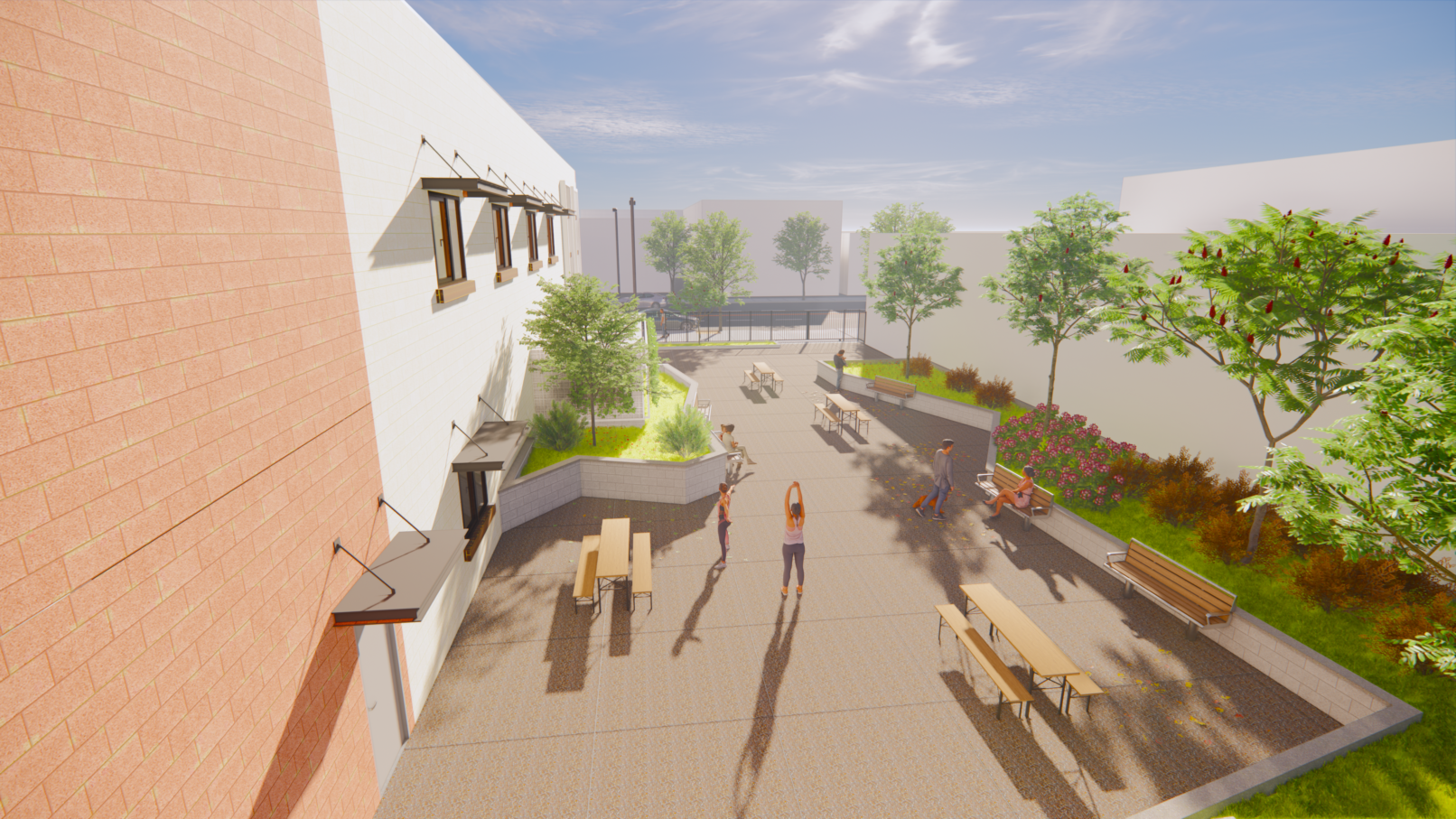 A perspective view of the rear yard with planter. Brick wall and stamped concrete floor.