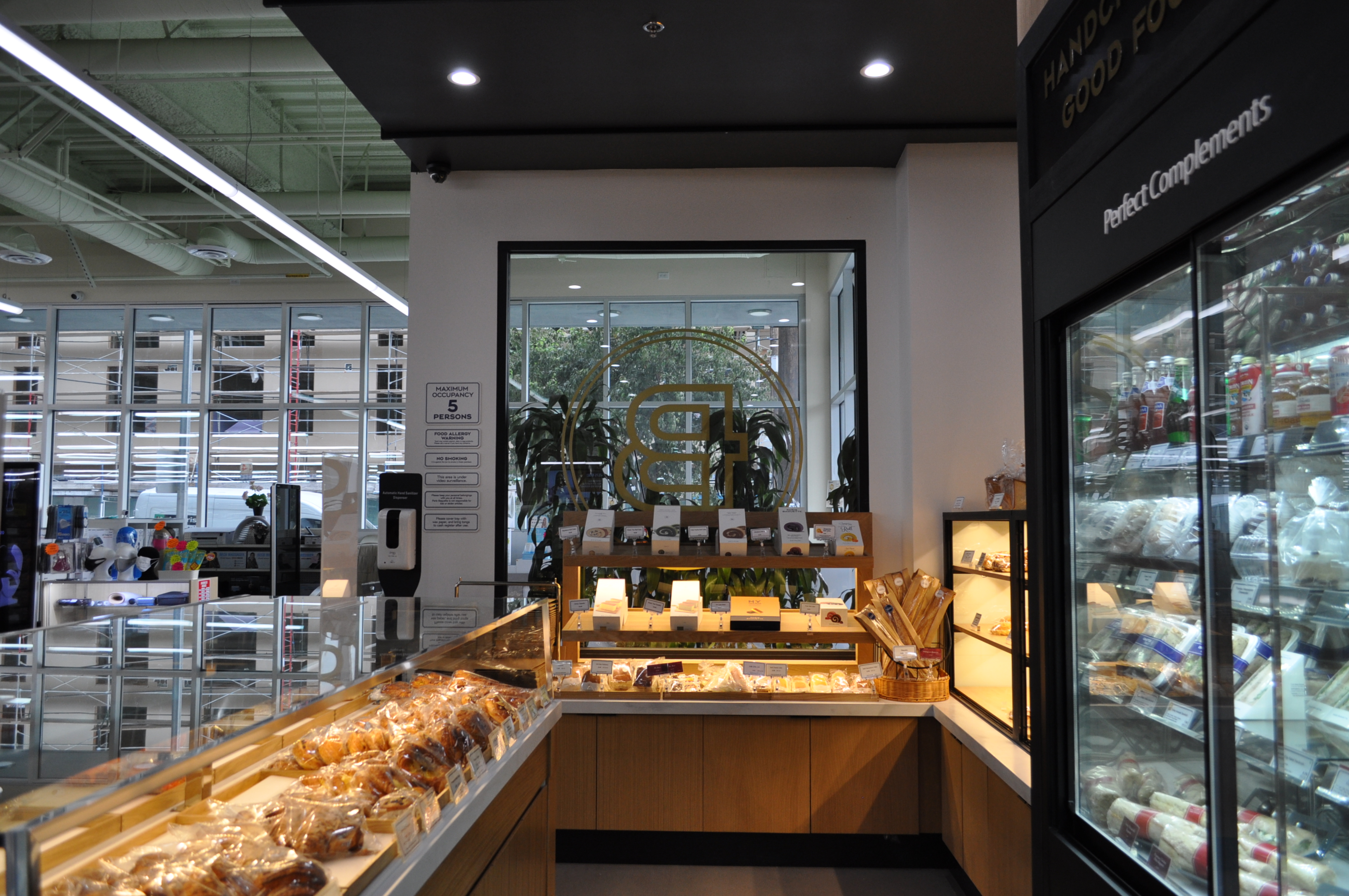 A building interior picture of paris baguette store. Bread display cases.