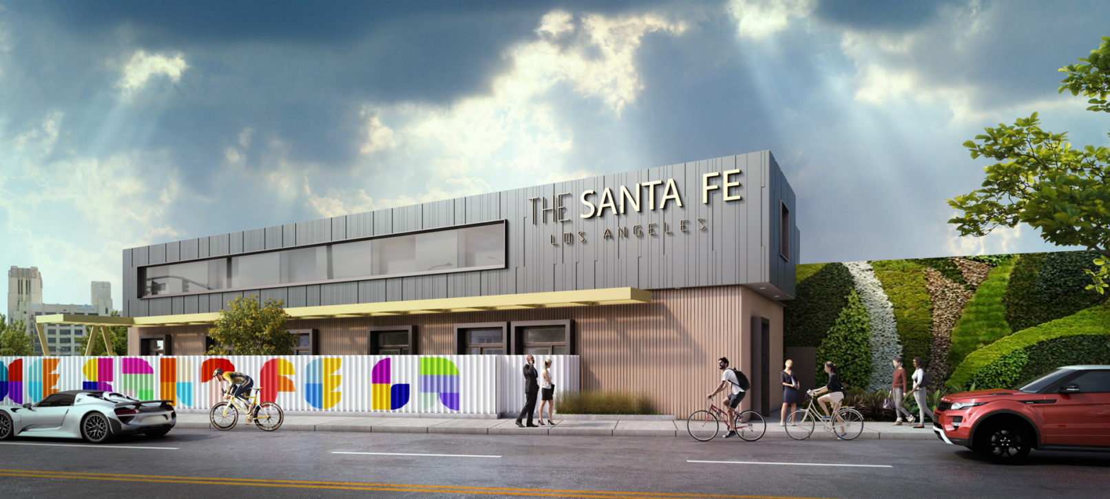 A perspective view of the commercial complex. Light brown at the bottom and concrete panel on top. Colorful fence and green exterior wall.