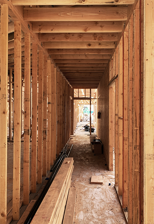 A construction photo of adult residential building. Wood wall framing and plywood floor.